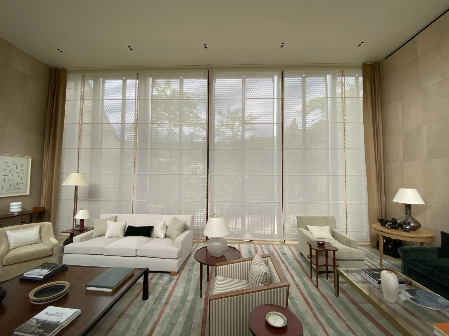 Tall living room with layered sheer blinds and curtains